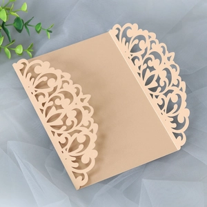 Detail of laser-cut floral pattern on champagne gold pearlescent paper invitation cover