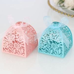 Detailed laser-cut hollow floral candy boxes with elegant organza ribbons in pink and blue