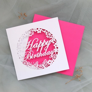 Macro detail of laser-cut butterfly Happy Birthday card with elegant pink envelope