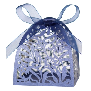 Detailed laser-cut hollow floral pattern on lavender gift box with blue ribbon bow