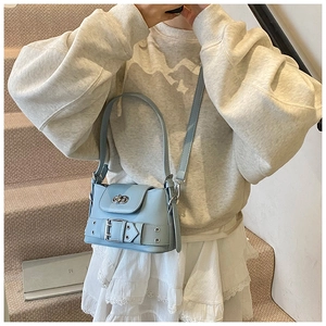 Détail du sac à bandoulière bleu clair avec boucle métallique et fermoir à verrou rotatif