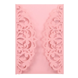 Detailed laser-cut vine patterns on pink pearlescent paper invitation cover