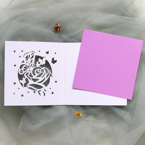 Détail de carte découpée au laser avec roses et papillons sur enveloppe violette