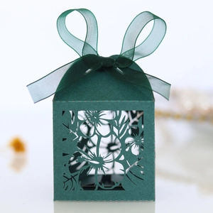 Detail showing laser-cut floral pattern and matching chiffon ribbon on dark green gift box