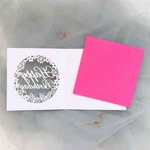 Detailed laser-cut birthday card with hollow butterfly patterns and pink insert paper