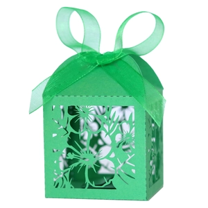 Green laser-cut gift box with intricate floral hollow design and ribbon bow for parties