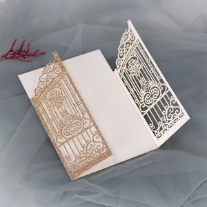 Macro detail of laser-cut glitter gold champagne wedding invitation with elegant hollow pattern