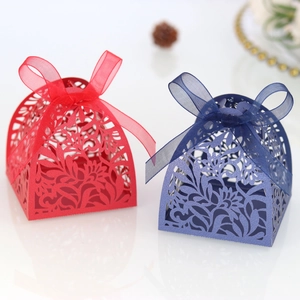 Laser-cut hollow gift boxes with floral patterns and satin ribbons in red and navy blue