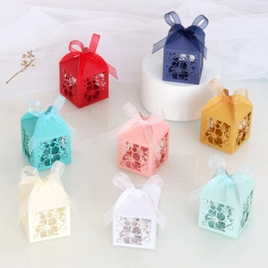 Detail of laser-cut gift candy boxes in eight colors with elegant sheer ribbon bows