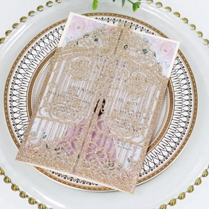 Macro detail of laser-cut gold glitter wedding invitation card with intricate gate design