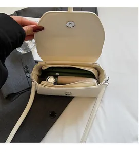 Interior view of off-white structured crossbody bag with spacious compartments