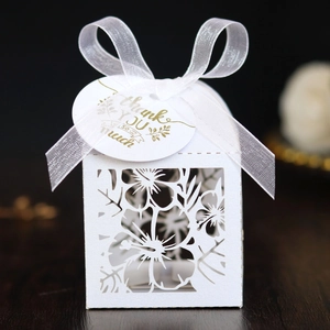 Detailed laser-cut candy box with white organza bow and golden thank you tag