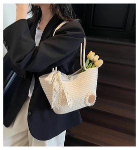 Detailed shot of cream woven tote bag with lace bow, sunflower decor and pearl closure