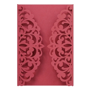 Close-up of laser-cut wedding invitation shell with elegant burgundy floral patterns