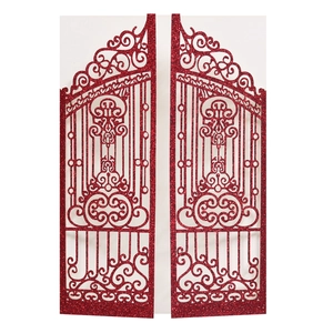Detail of red glitter laser-cut invitation featuring an intricate gate design with texture