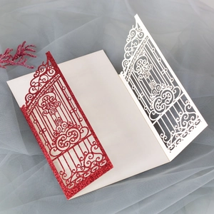 Detail of laser-cut glitter wedding invitation with elegant hollowed-out gate design
