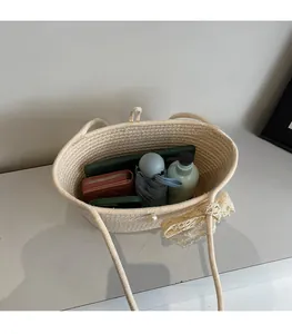 Spacious interior of a straw tote bag showing storage for umbrella and wallet
