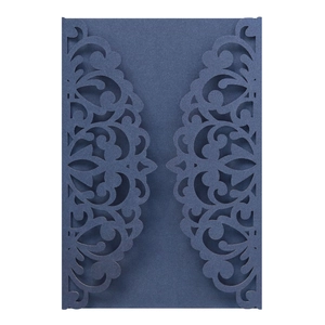 Close-up of laser-cut floral pattern on dark green pearlescent paper wedding invitation