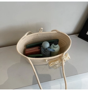 Detail view of woven tote bag interior showing space for tablet, wallet and umbrella