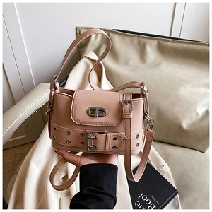 Détail d'un sac seau rose avec fermoir rotatif argenté et sangle à œillets métalliques