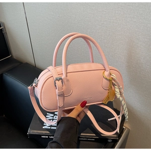 Pink lychee texture boston bag with tennis racket charm and striped silk scarf detail