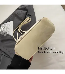 Detailed bottom view of cream tote bag featuring silver sequin seams and flat base design