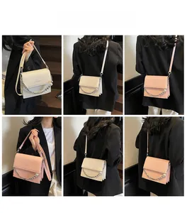 Detail of stone pattern crossbody bag with pearl chain and adjustable shoulder strap