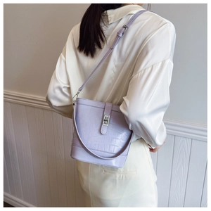 Detail of lavender bucket bag with crocodile texture and silver twist lock closure