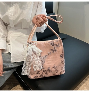 Detail of pink silk tote with sequin butterfly and lace pearl bow ornament