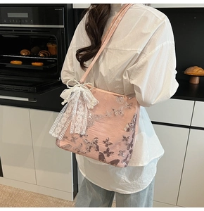 Detail of pink embroidered tote bag with silver sequin butterflies and lace bow