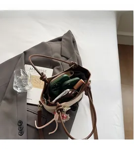 Top view of a beige bucket bag interior showing spacious capacity for phone and makeup