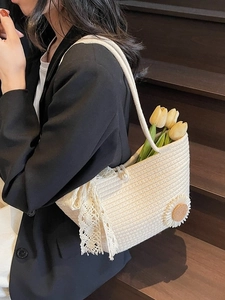 Chic summer woven tote bag featuring lace ribbon and daisy detail on wooden stairs