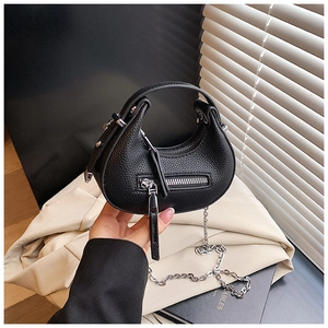 Detail of black lychee grain crescent bag with silver chain and decorative zipper