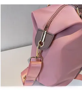 Détails de la mercerie dorée et du nylon rose sur ce grand sac cabas pour femme