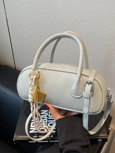 Litchi pattern leather handbag in dusty blue with tennis racket and abacus charm detail