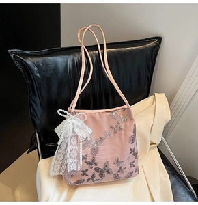 Detail of pink embroidered tote bag with sequined butterflies and lace pearl bow