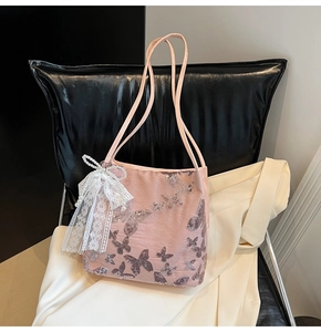 Detail of pink embroidered tote bag with silver sequin butterflies and lace bow
