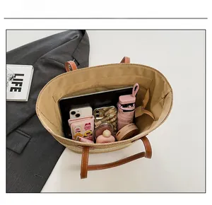 Interior view of large straw tote bag showing spacious storage for daily essentials
