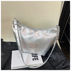 Detail view of silver hobo bag with metallic texture, thick chain strap and LIFE magazine