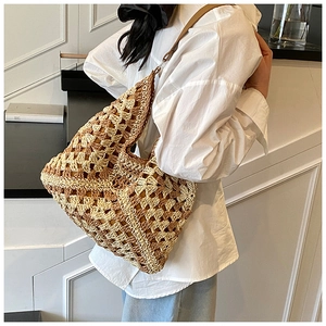 Detail of hollow woven straw tote showing beige and brown crochet diamond pattern