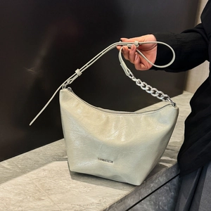 Chic cream leather underarm bag with silver chain strap and half-moon bucket design