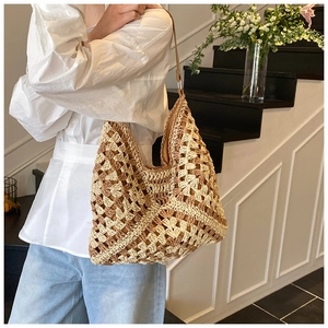 Close-up of tricolor hand-woven straw tote bag with intricate crochet hollow pattern