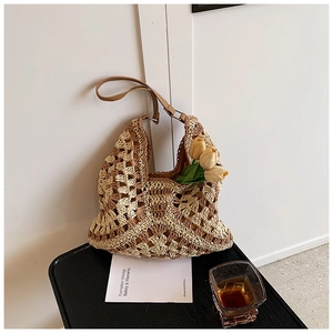 Close-up of handmade crochet beach bag with geometric patterns and brown leather strap