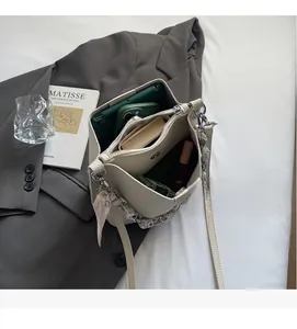 Top view of cream bucket bag interior showing spacious compartments and pebble leather