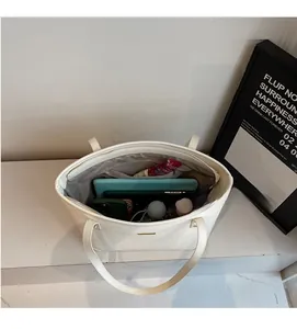 Top view of white leather tote bag interior showing large capacity for tablet and items