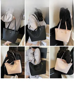 Detail view of large tote bag showing woven texture and metal rivets on pink and black styles