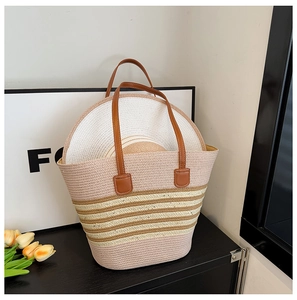 Close-up of pink and beige striped woven tote bag with matching straw sun hat set