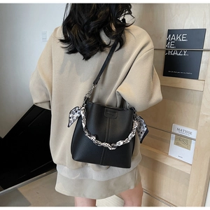 Detailed back view of a black pebble leather bucket bag with leopard print scarf wrap