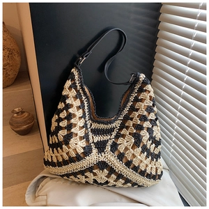 Detail of hand-woven cotton beach tote with geometric patterns and leather strap
