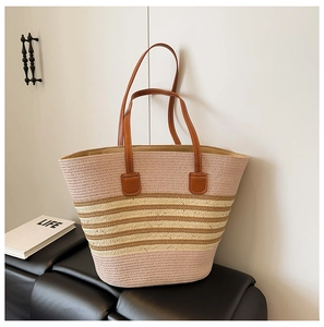 Detail of pink and brown striped woven tote bag with long leather shoulder straps